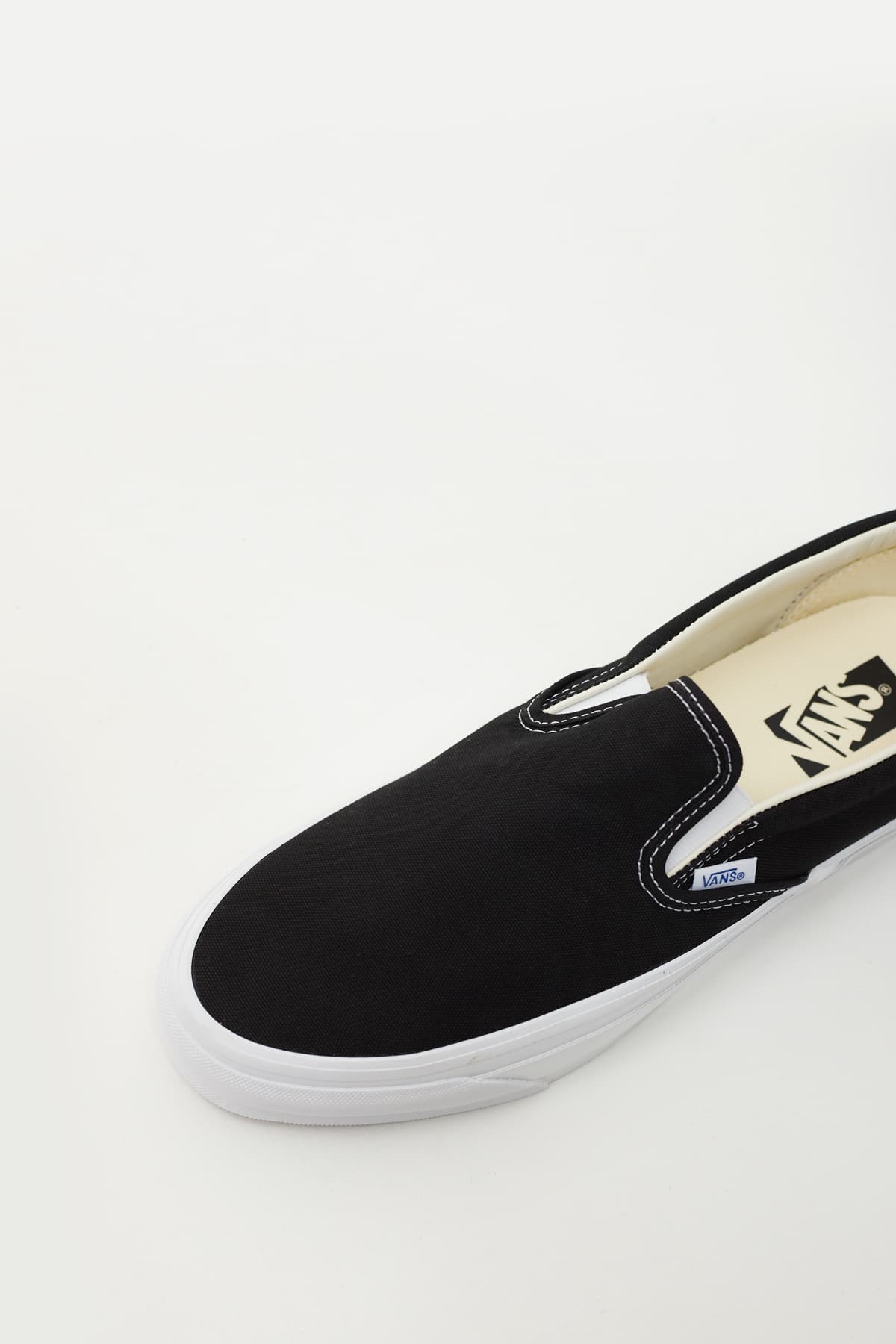 Black slip on vans white sole on sale