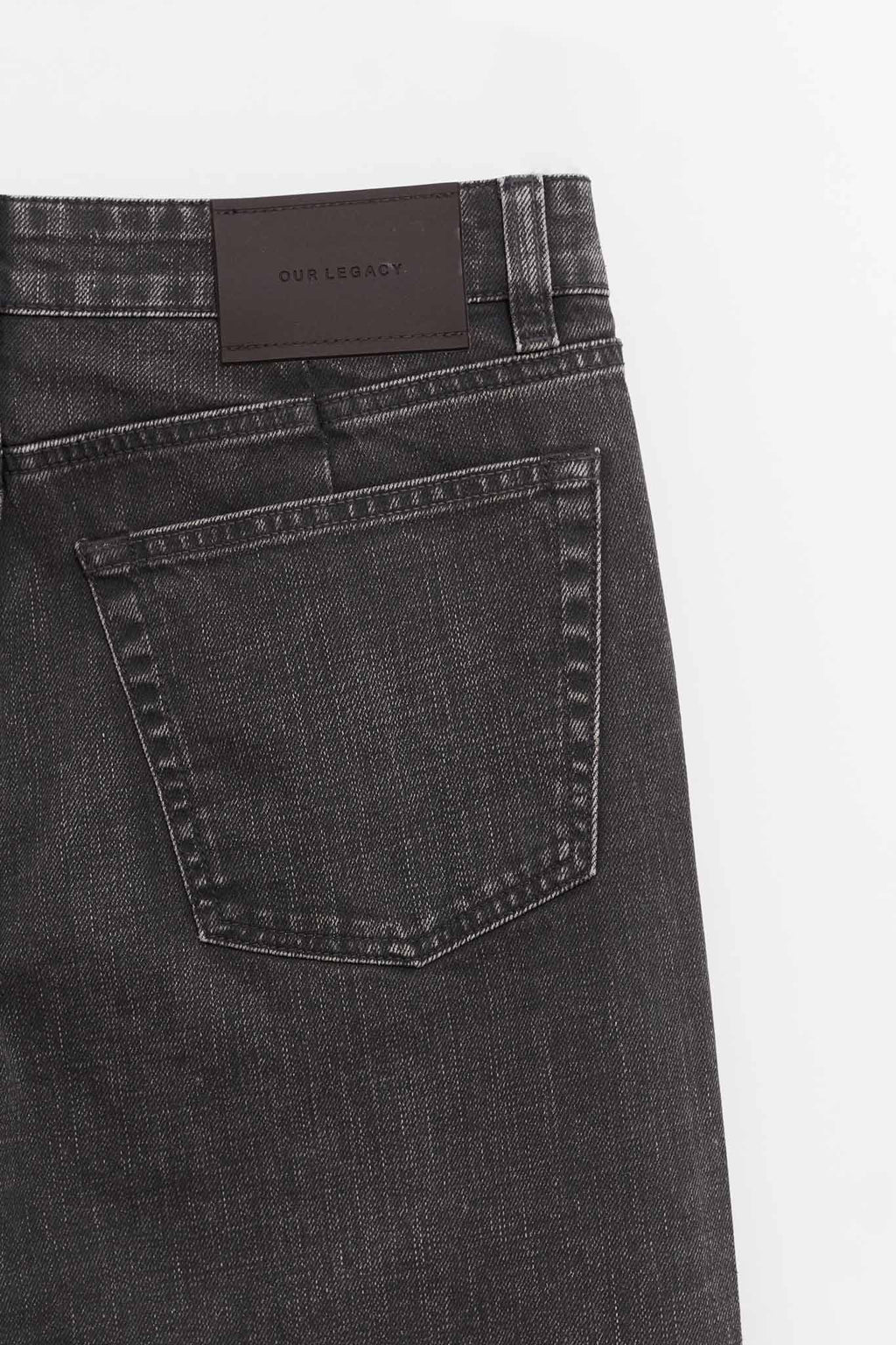OUR LEGACY BLACK COATED TREBLE CUT TROUSERS